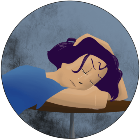 Femme en pleurs, avachie sur une table, la tête sur ses bras.